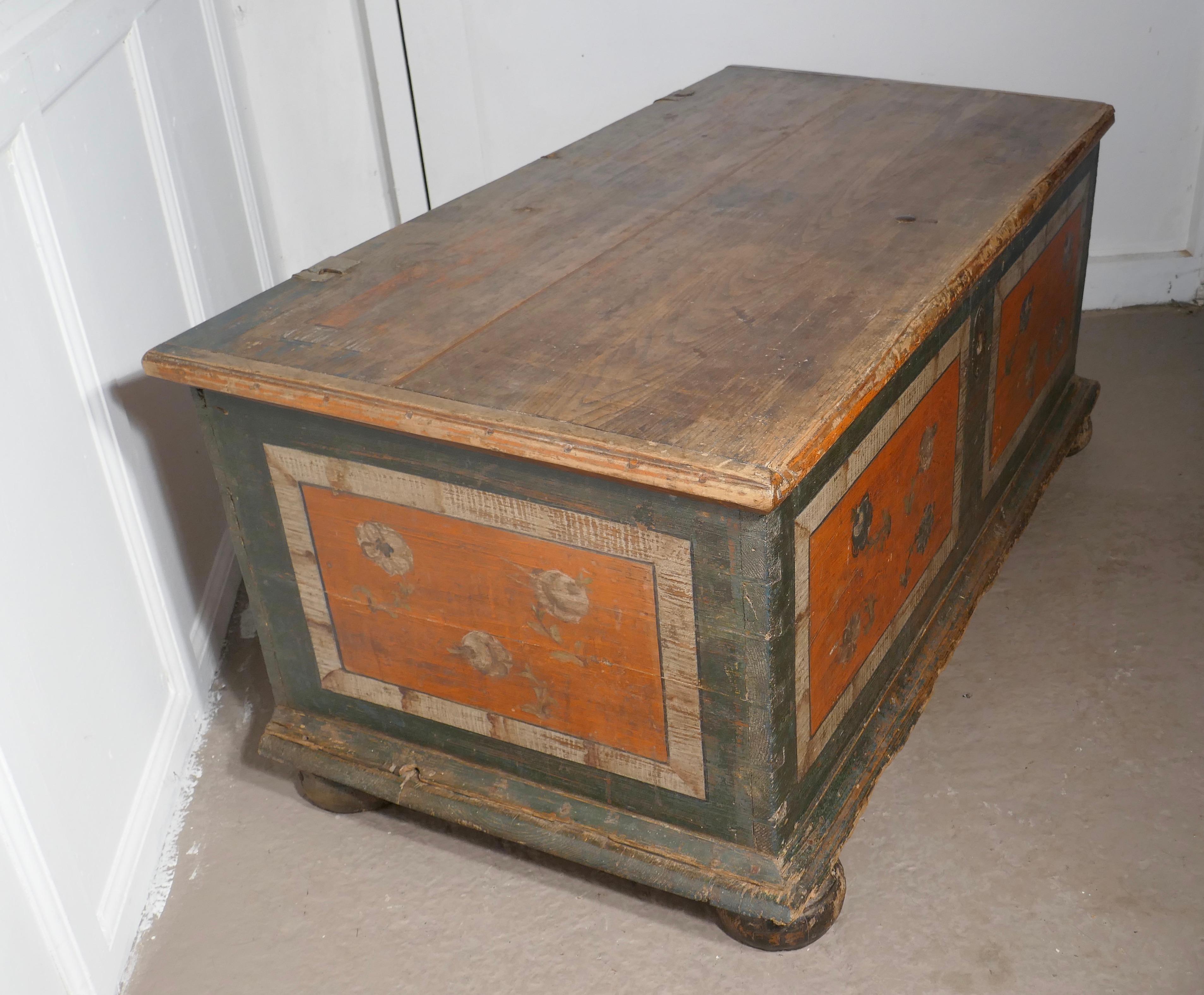 European Folk Art painted pine chest

This is a lovely piece, it has painted decoration, very visible on the front and sides though the decoration on the top has mostly worn away

The chest stands on big bun feet it has had a well used life
The