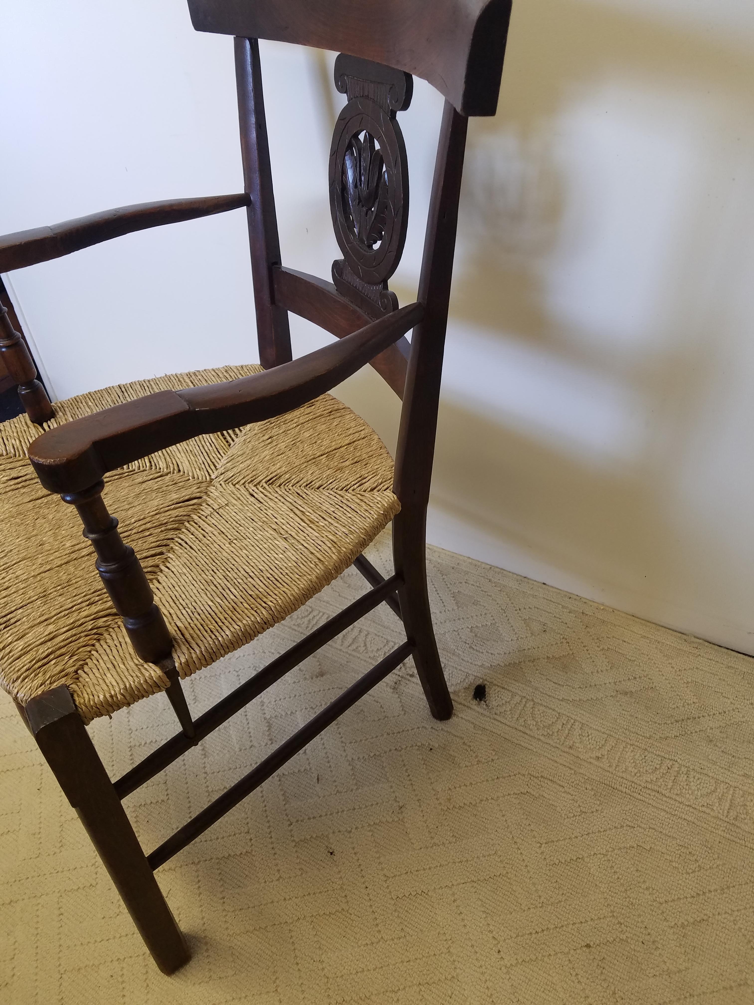 Wonderful European turn of the century oak armchair with carved back splat, shapely arms and curved and turned stretchers. Rush seat replaced at a later date.
Very good condition.
Measures: 24 W x 23 D x 36 H. Seat height 17.25.
 