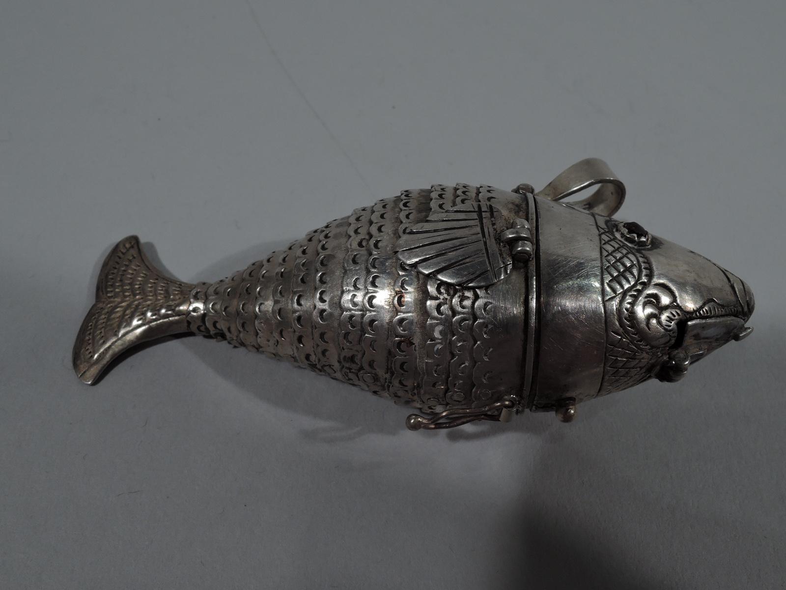 European silver fish-form spice box, 19th century. Hinged head and lower mouth, and faceted red eyes. Articulated and scalloped wide body, and hinged fins and tail. Loose-mounted ring. Unmarked.