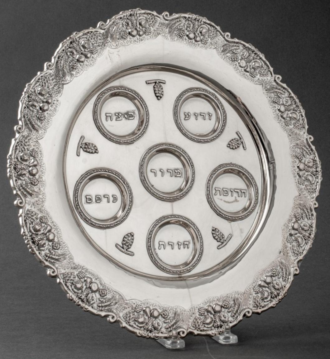 European Judaica silver seder plate with scalloped edges and with rim cast and chased in high relief, the cavetto with the traditional recesses with Hebrew inscriptions and stamped 