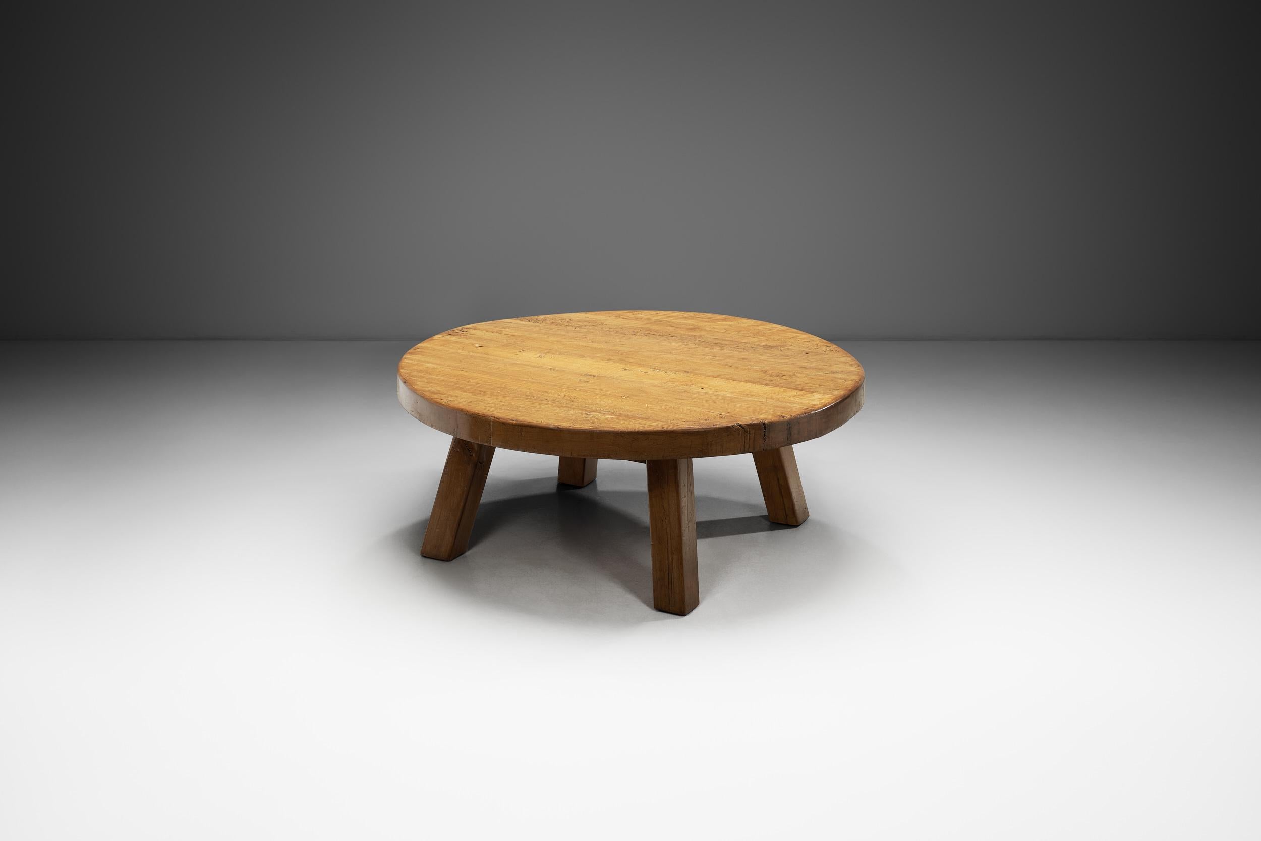 This coffee table embodies the essence of European mid-century design, with its distinctive features that recall a time when form and function were paramount. Crafted from solid wood, this table exudes a rustic charm and robust aesthetic that is