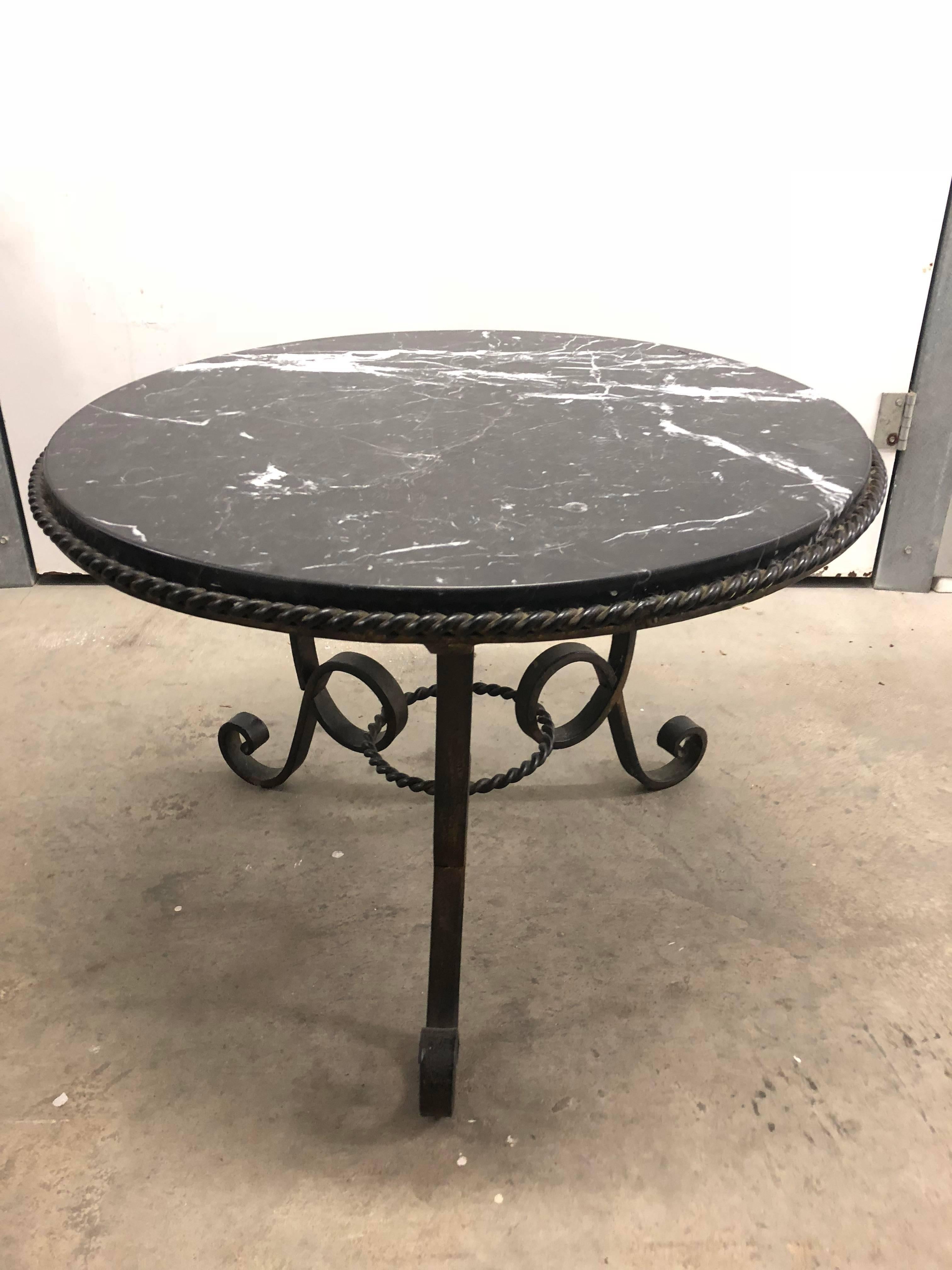 Round marble top coffee table, gilt iron base with rope design trim.