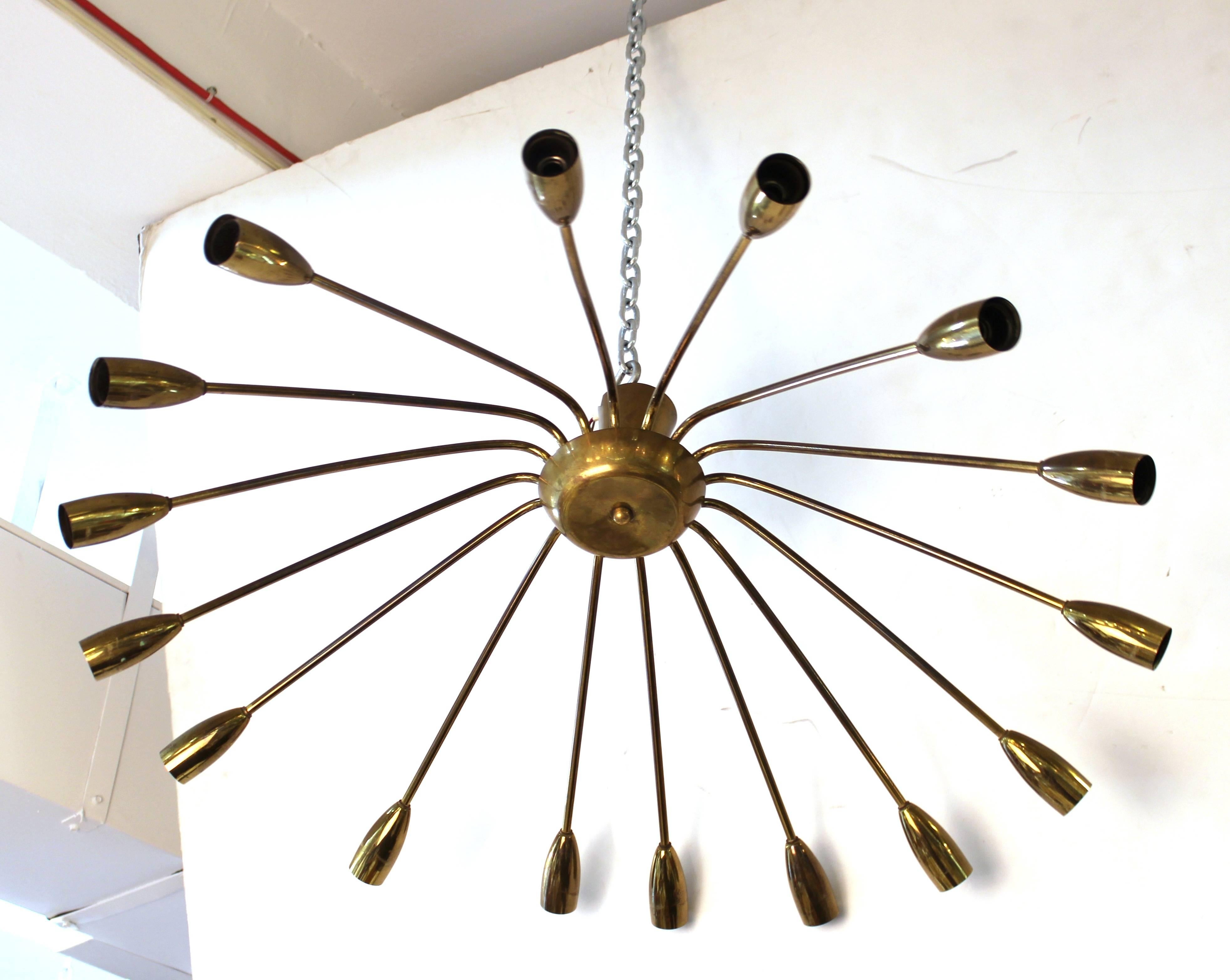 A Mid-Century Modern spider chandelier in metal, made in Europe. The piece has 16 individual arms and is in good vintage condition.