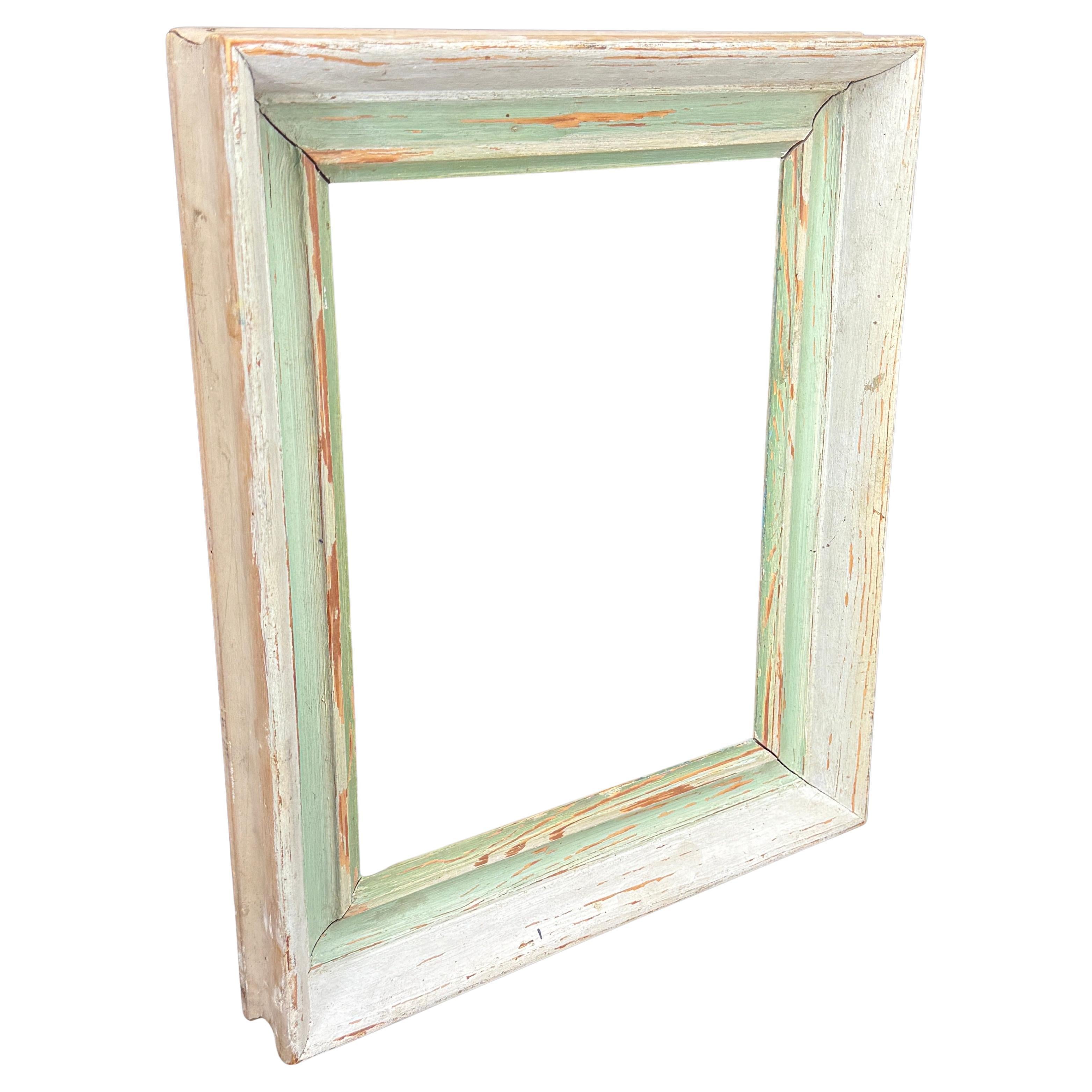 As found on a European buying trip, a fabulous wooden rectangular decorative frame with fantastic patina. This frame has its original whiteish paint with green accents. The frame will accommodate artwork 9.5