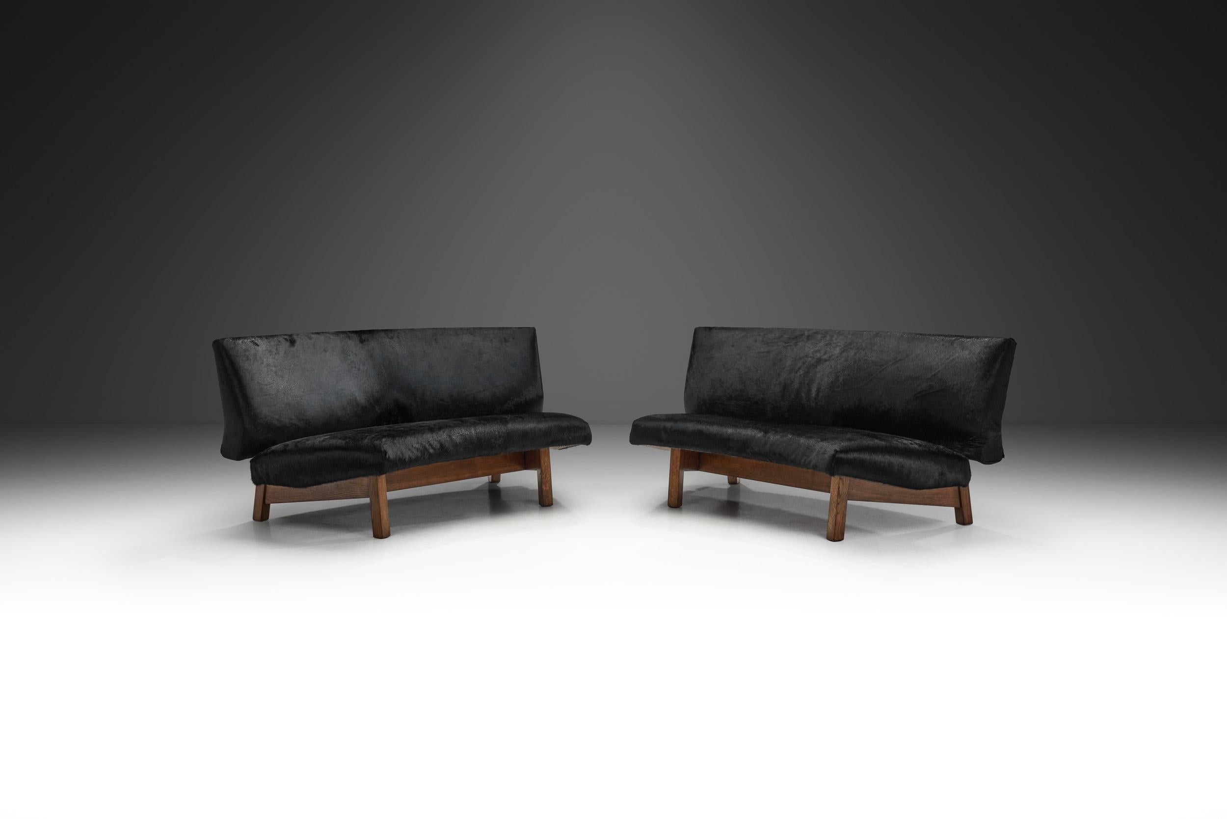 This unique curved sofa consists of two parts and whether the parts are standing next to each other or together, the design is simple and striking.

The two separate part construction allows for significant versatility; the sofas can be placed