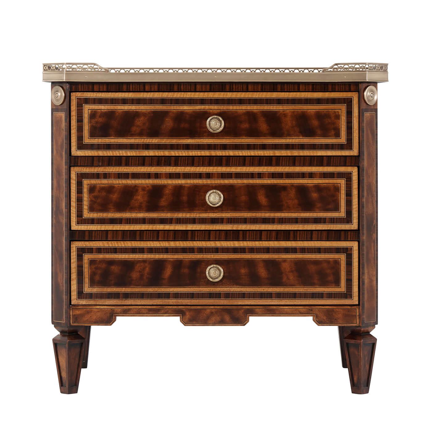 A flame mahogany, Movingue and rosewood banded nightstand, the rectangular top with canted corners and a three quarter brass gallery, three drawers with fine brass handles and on paneled tapering legs.

Dimensions: 28