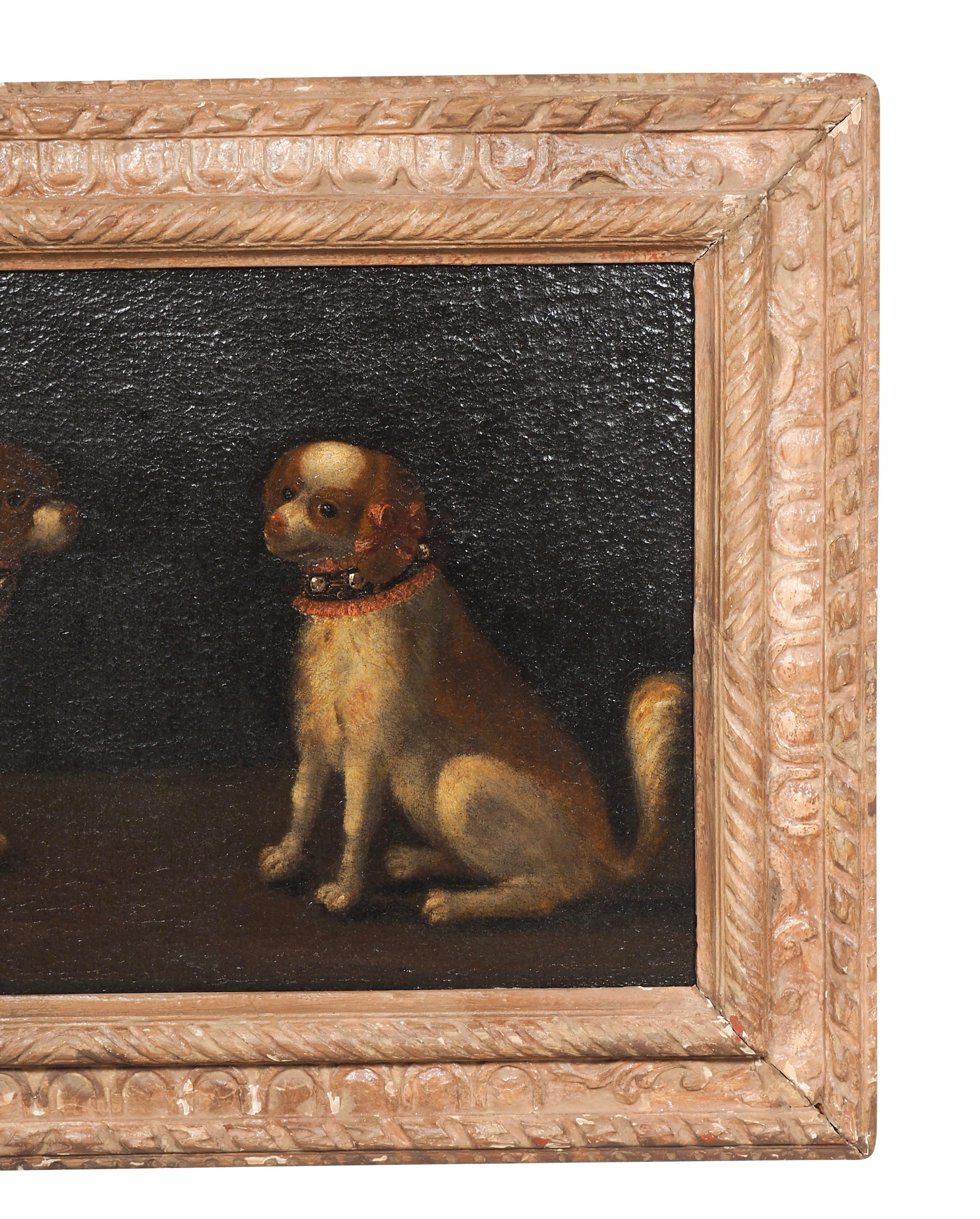 Mit zwei Spaniels, einem sitzenden und einem stehenden. In einem Rahmen aus vergoldetem Holz.