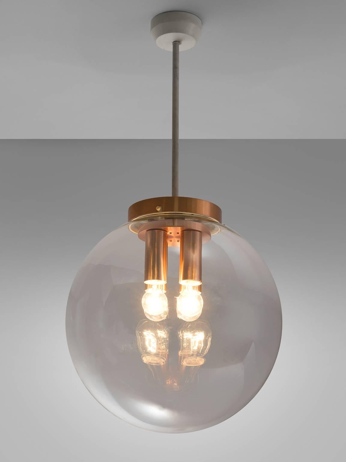 Pendant, in copper and glass, Europe, 1970s. 

This pendant with copper fixture is Minimalist and modest. The clear glass shade is attached to a circle copper plate that holds four different copper fixtures that hold a light bulb each. This results