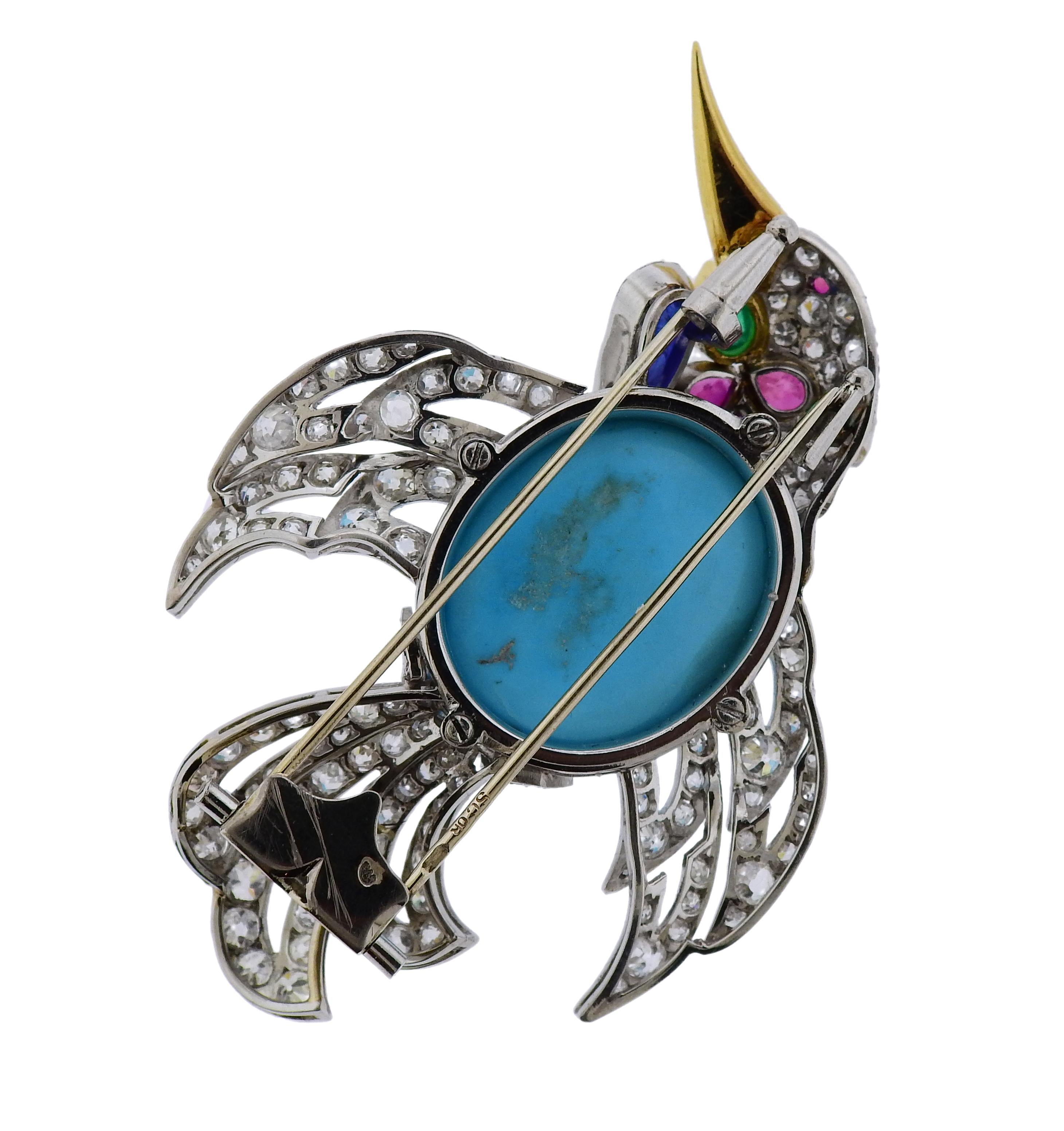 Austrian platinum bird brooch, set with a turquoise, carved sapphire, emerald cabochon, faceted rubies and approx. 13 carats in diamonds. Brooch measures: 63mm x 45mm. Weight is 32 grams. Marked: SG OK, assay marks.