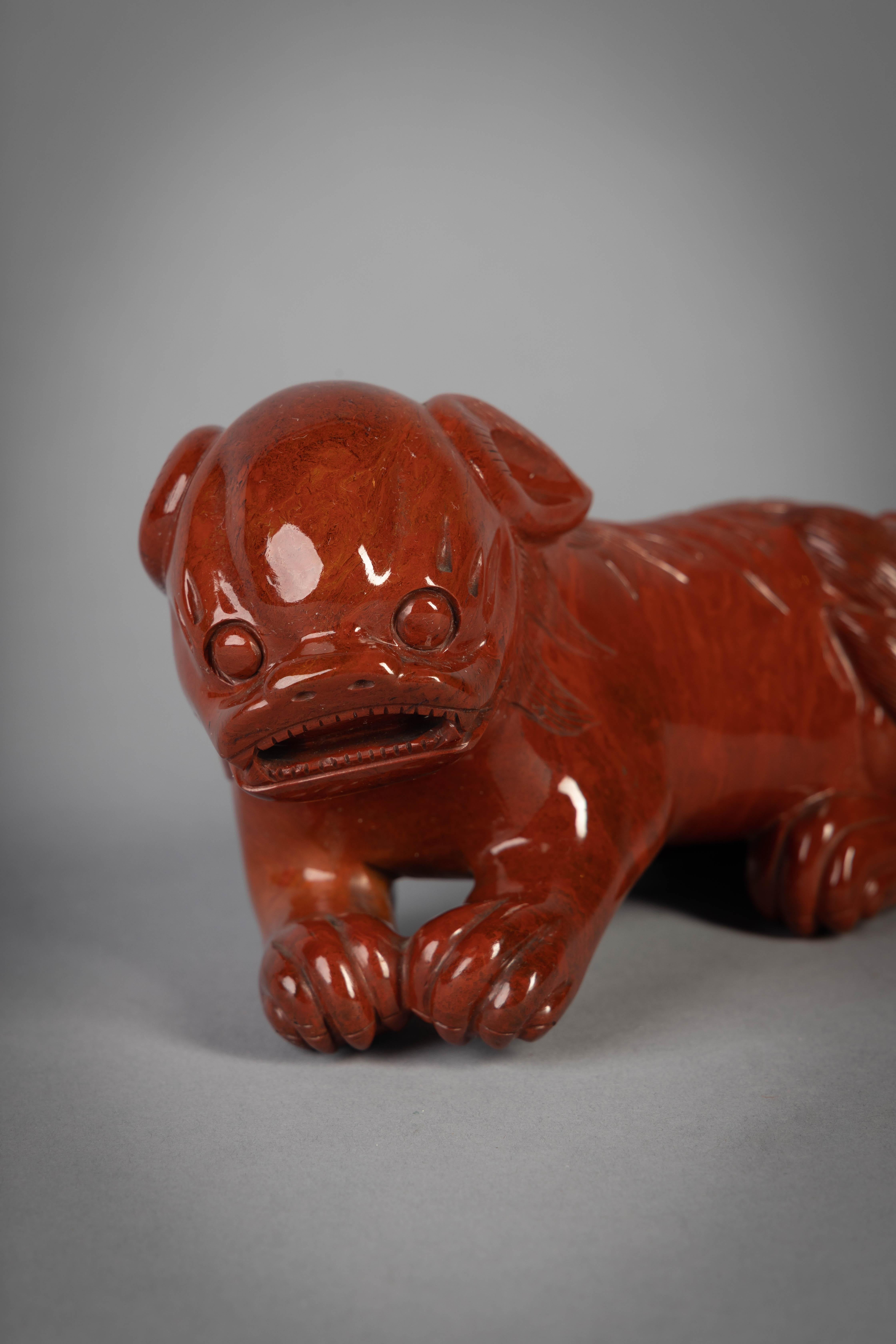 European red jasper figure of a fantastic foo dog, 20th century.