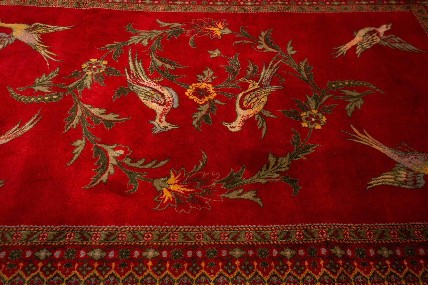 This is an antique European Cherry Field rug woven circa ca. 1880. This piece has a bird and flower ring design with beautiful cherry color field. This is a luxurious piece that will add charm to your interior and will make your collection so