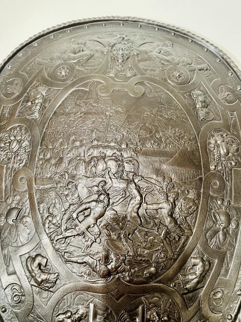 Medieval European shield in bronze with careful chiseling depicting a battle circa 1700
