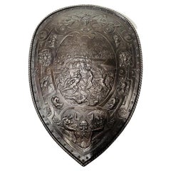 European shield in bronze with careful chiseling depicting a battle circa 1700