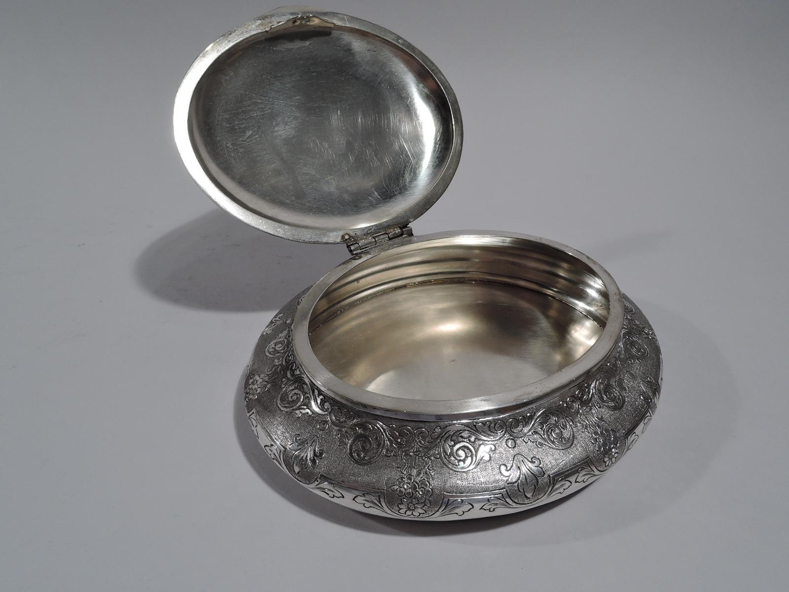 Turn of the century European 800 silver keepsake box. Oval and bellied. Cover hinged and domed with cast elephant finial. Engraved scrolls, flowers, and leaves on stippled ground. Marked “800”. Weight: 13 troy ounces.