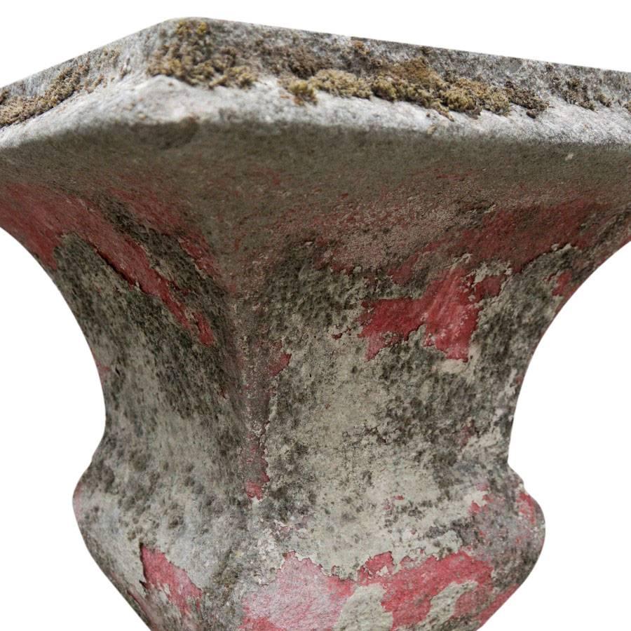 Purchased in France this cast stone vessel has red paint residue and moss patina.

 