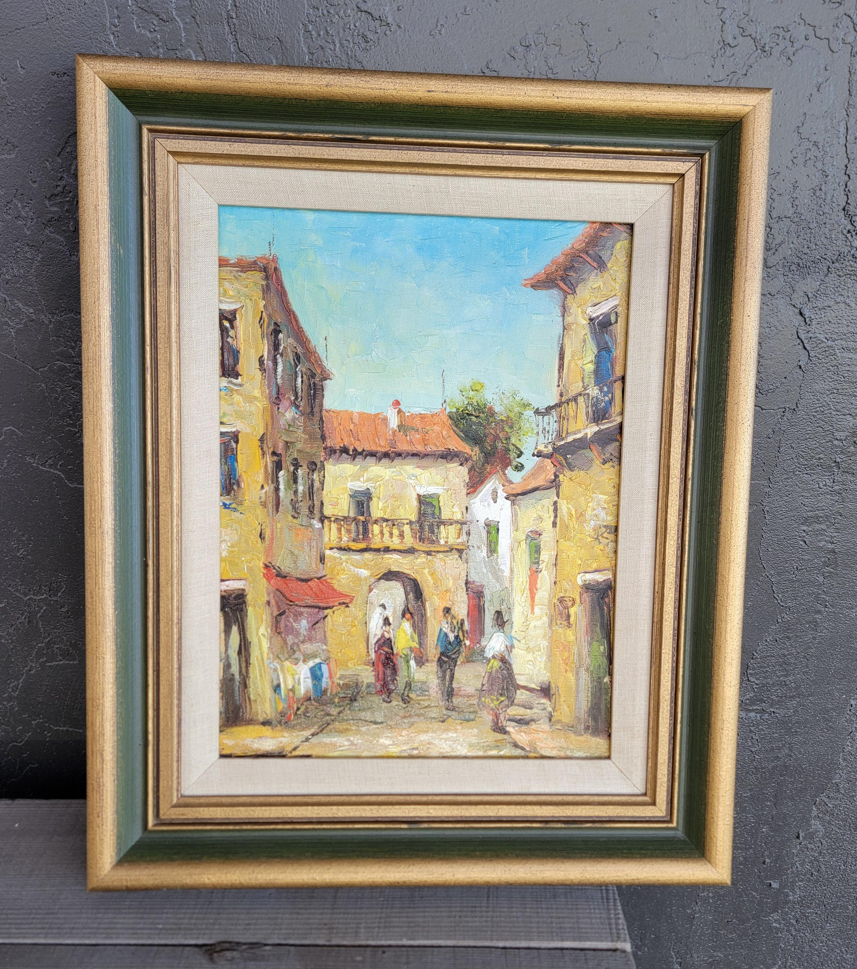 Two accompanying street scene oil paintings of a European town. Appears to be France. Painted on canvas with original painted wood frames.

Each measures 18