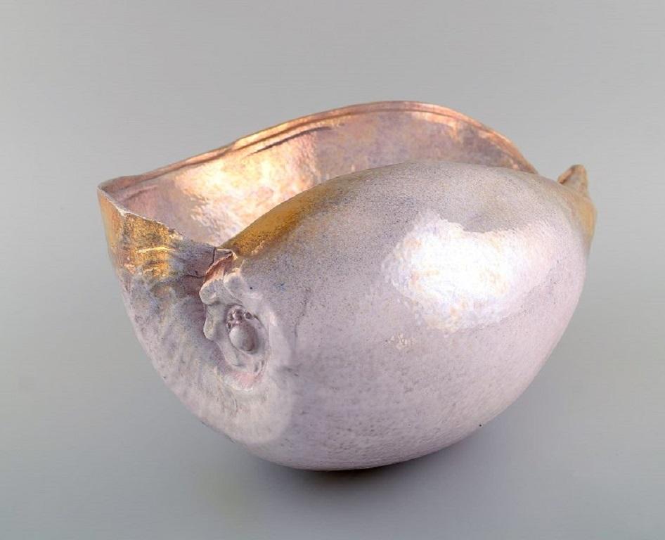 European studio ceramicist. Large unique sculpture designed as a conch in glazed ceramics. 
Beautiful glaze in delicate pink and gold. Late 20th century.
Measures: 35 x 16 cm.
In excellent condition.