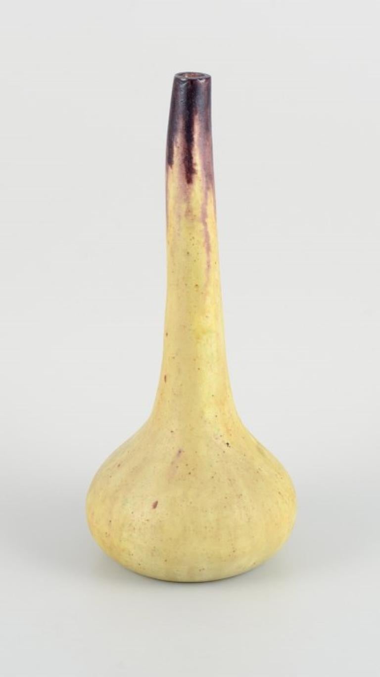 European studio ceramicist. Tall narrow-necked ceramic vase with yellow and brown glaze.
1960s.
Indistinctly signed.
In perfect condition.
Dimensions: H 32.0 cm x D 14.0 cm.