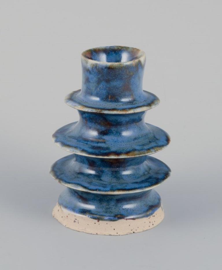 European studio ceramicist. Two unique ceramic candleholders. 
Glaze in blue and brown shades.
Ca. 1980s.
Signed MR.
Perfect condition.
Blue: H 9.8 cm x D 6.8 cm.