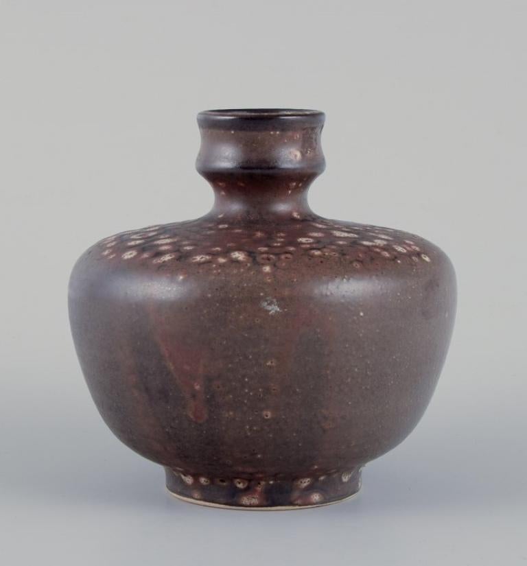 European studio ceramicist. Unique ceramic vase. Glaze in brown tones.
Ca. 1980s.
Stamped 