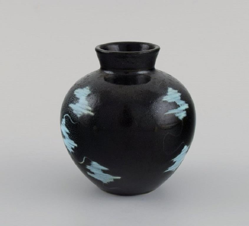 European studio ceramicist. Unique vase in glazed stoneware. 
Light blue touches on black background. 
1960s / 70s.
Measures: 9 x 8.5 cm.
In excellent condition.
Stamped.