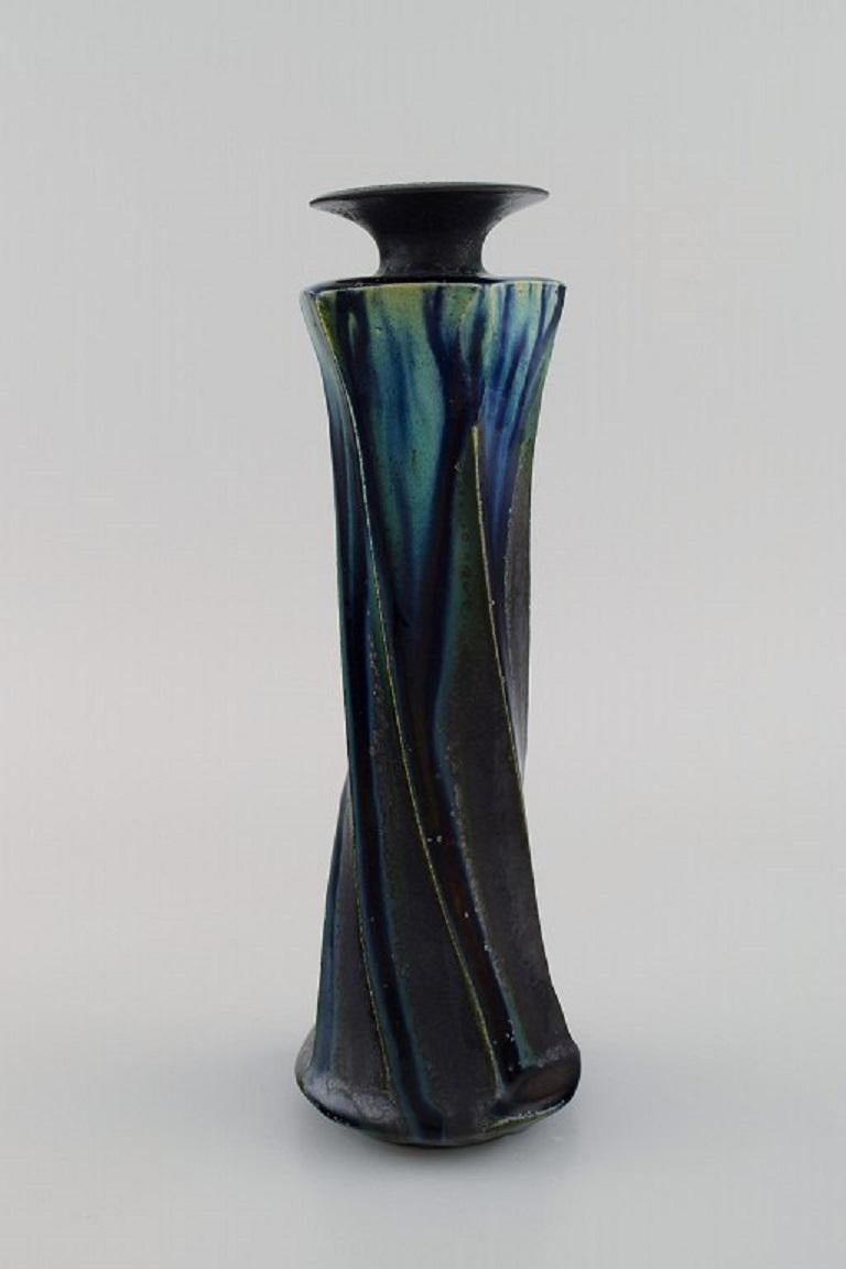 European studio ceramicist. Unique vase in glazed stoneware. 
Turned shape. Beautiful glaze in deep blue-green shades. 1920s / 30s.
Measures: 26 x 8.5 cm.
In excellent condition.
Stamped.
Provenance: Collection David Wilkie Cooper.