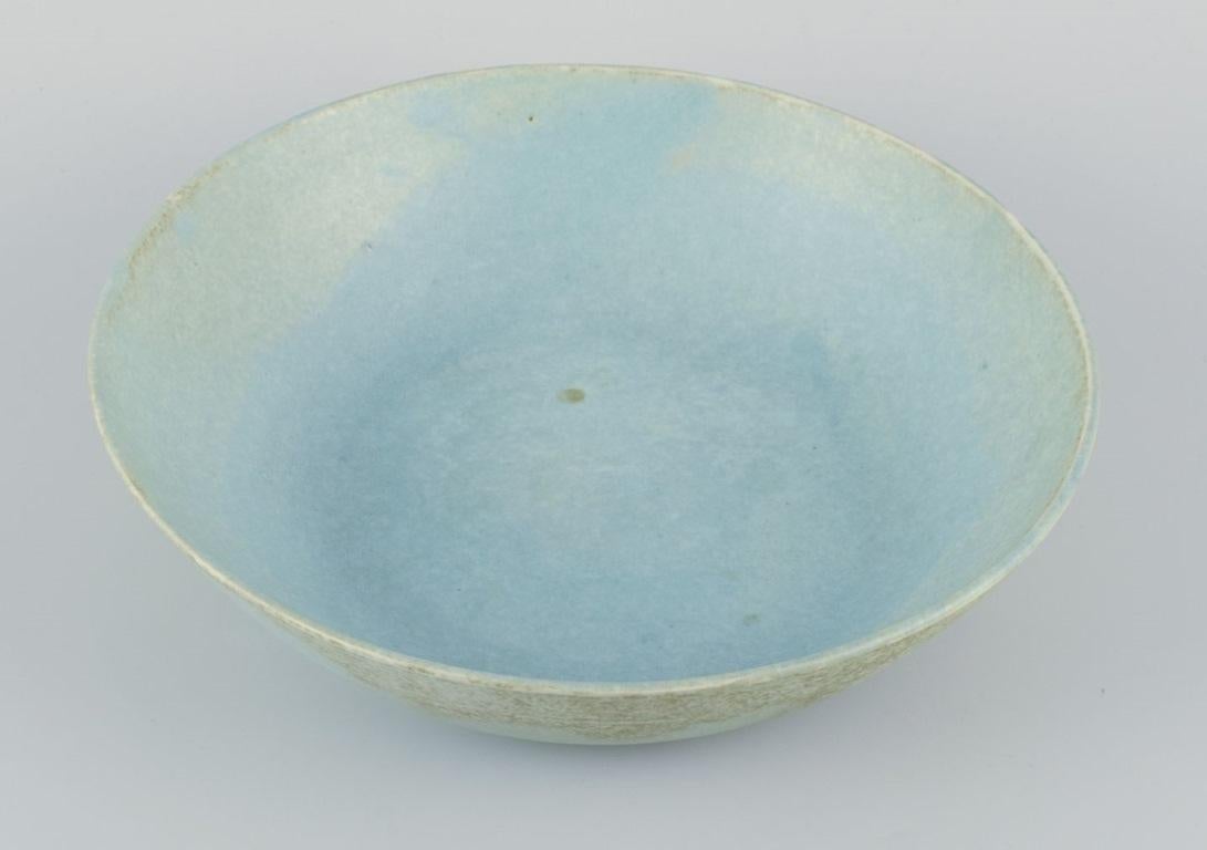 Glazed European studio ceramicist. Very large bowl with glaze in light blue tones. For Sale