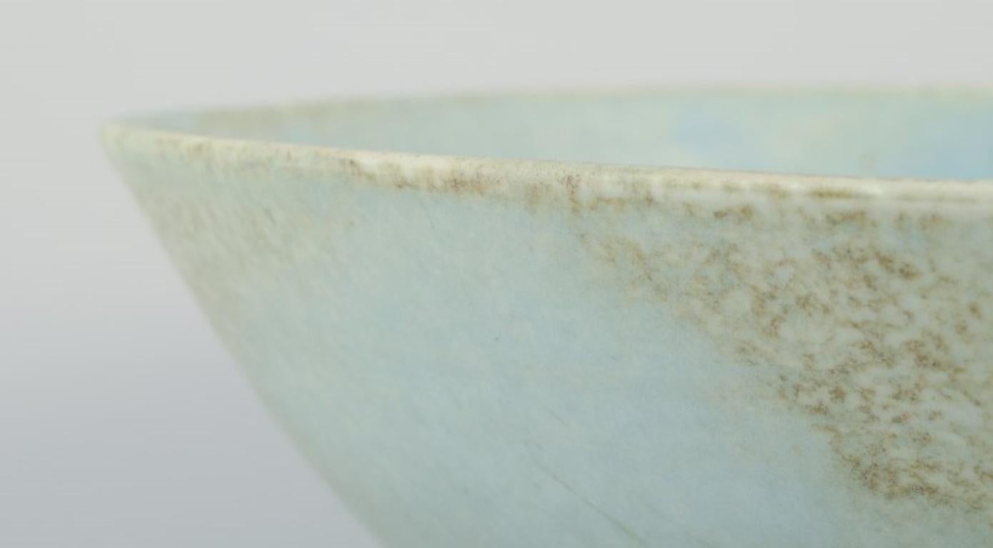 Late 20th Century European studio ceramicist. Very large bowl with glaze in light blue tones. For Sale