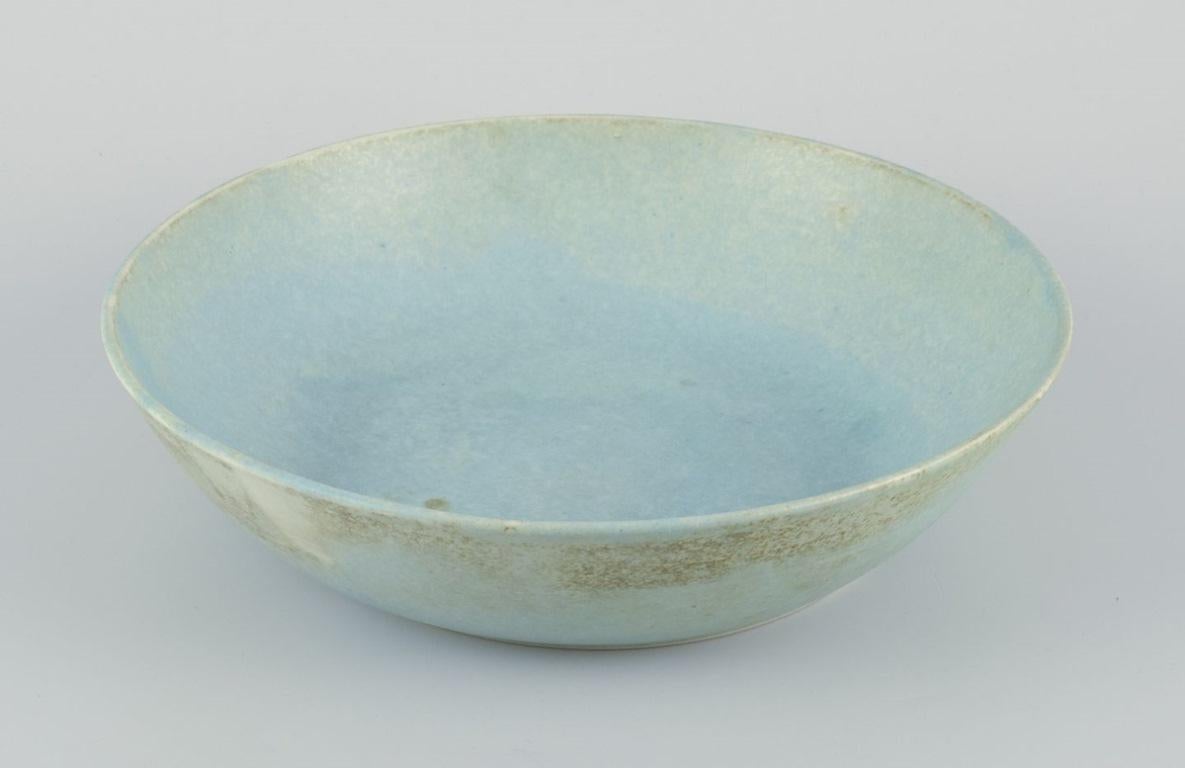 European studio ceramicist. Very large bowl with glaze in light blue tones. For Sale