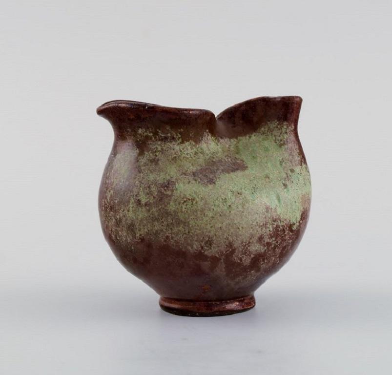 European studio ceramist. Small unique vase / jug in glazed stoneware. 
Beautiful luster glaze. 1960s / 70s.
Measures: 7.5 x 7 cm.
In excellent condition.
Stamped.