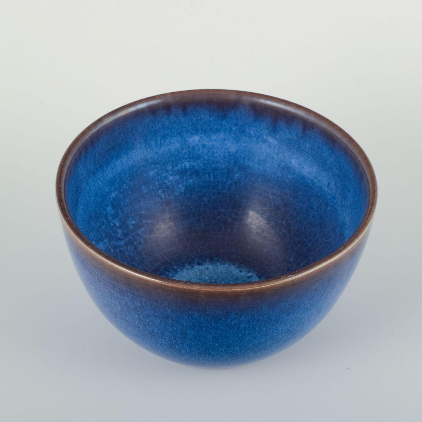 European Studio Potter, Bowl, c. 1970s.
Ceramic bowl made by a European studio potter around the 1970s. 
The bowl has a harmonious rounded form and is decorated with a deep blue glaze, shifting from an intense blue tone at the center toward a