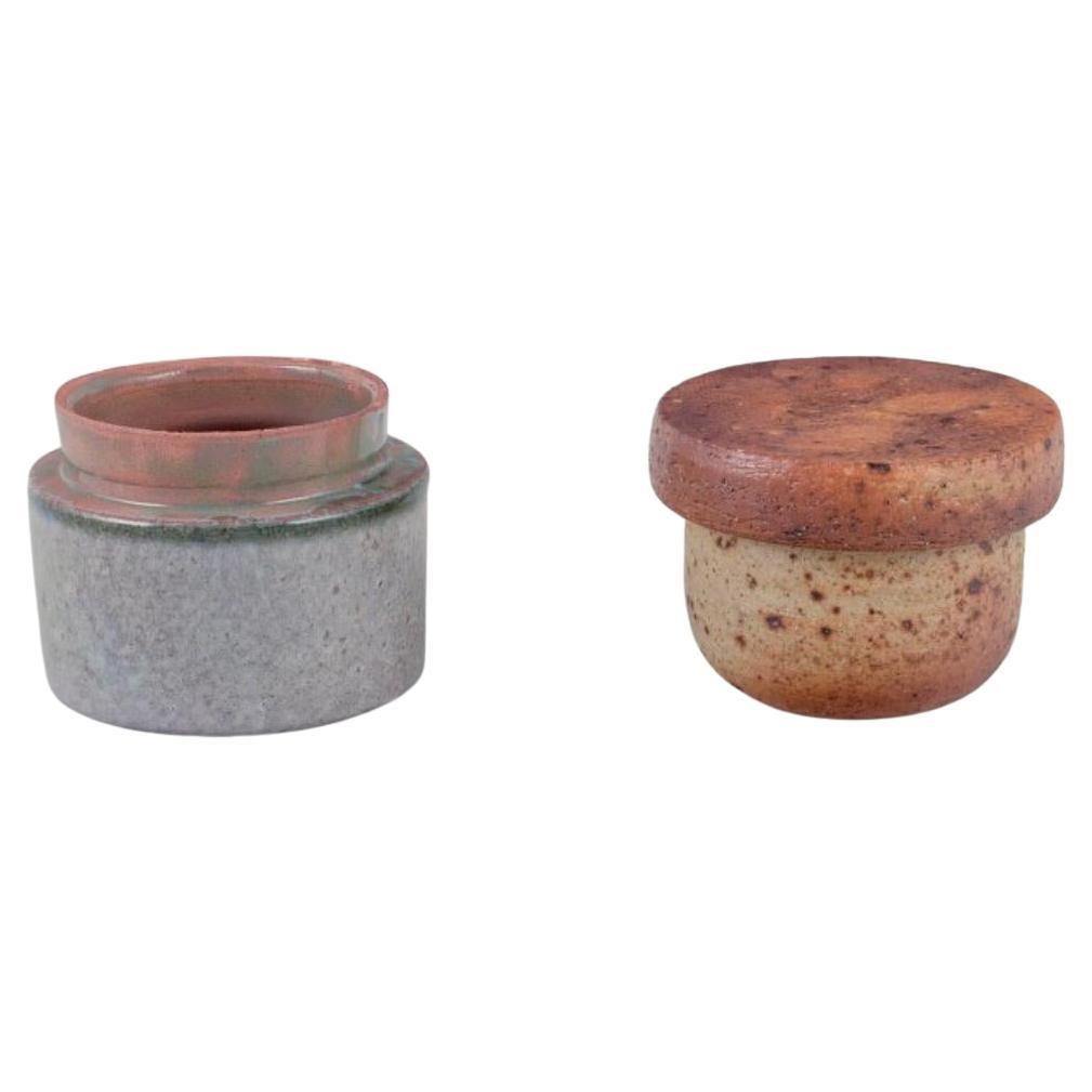 European studio potter. Two unique ceramic jars, one with a lid.