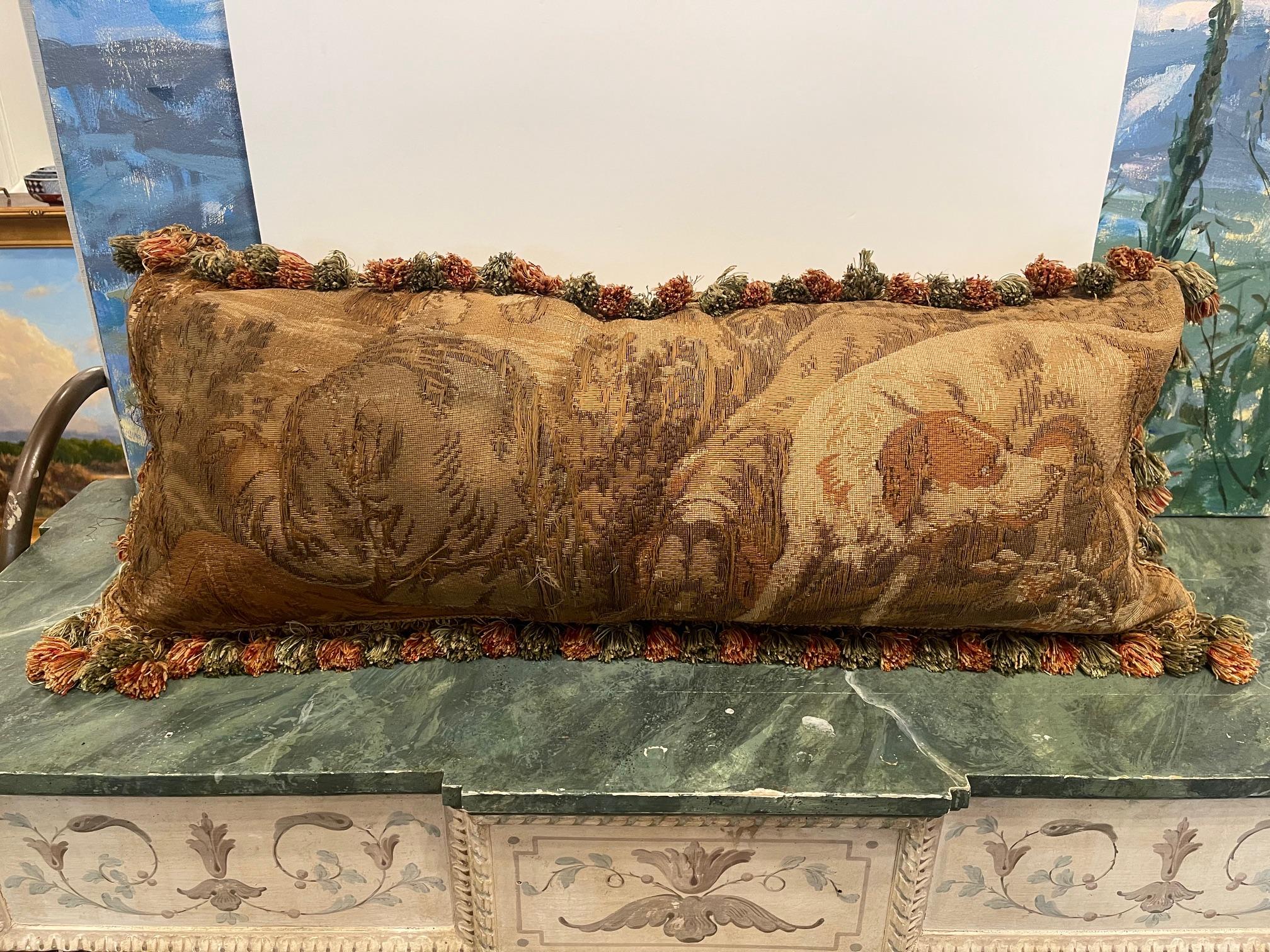 European Style Pillow Made from an 18th Century Tapestry Fragment depicting hunting dogs and their owner.  Pillow is backed with chenille, feather down fill, invisible zippers, and decorated with Silk Trim.