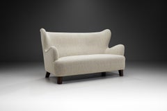 European Upholstered Wingback Sofa with Stained Wood Feet, Europe 20th Century