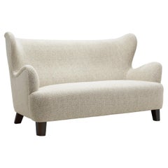 European Upholstered Wingback Sofa with Stained Wood Feet, Europe 20th Century