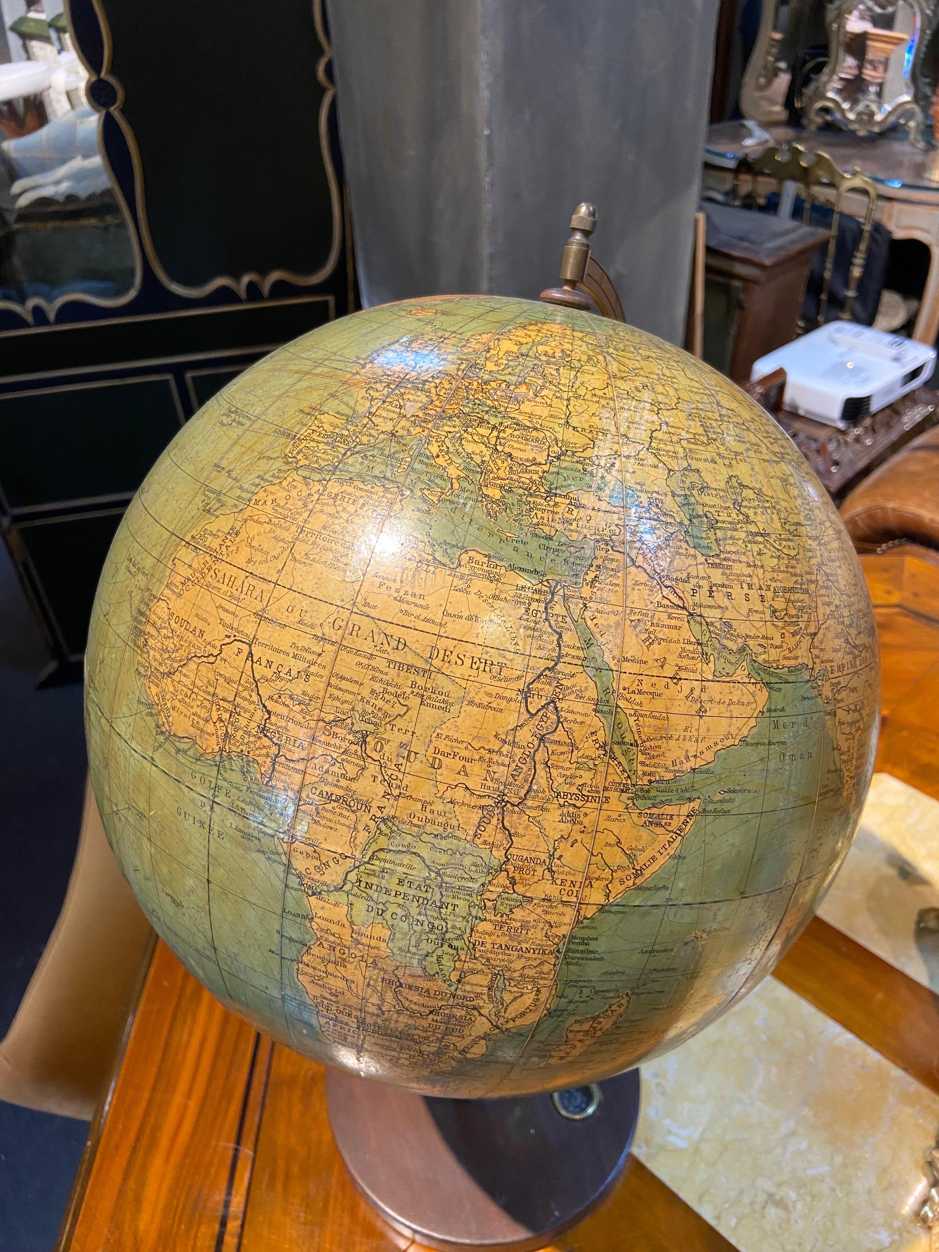 Vintage handmade world globe standing on a base with small compass in the bottom. The piece is in fare condition with no restaurations ever made.
France, circa 1950
