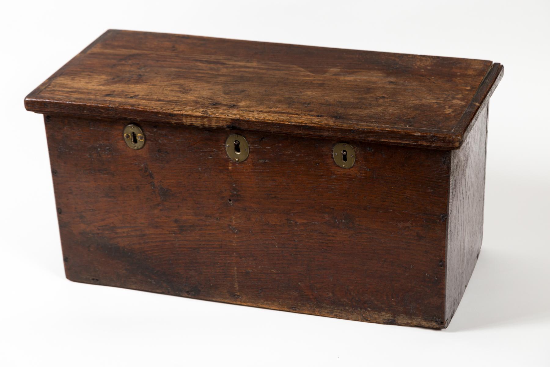 European Walnut Storage Chest, early 19th Century. An early chest with triple brass locks and hand-forged iron strap hinges.