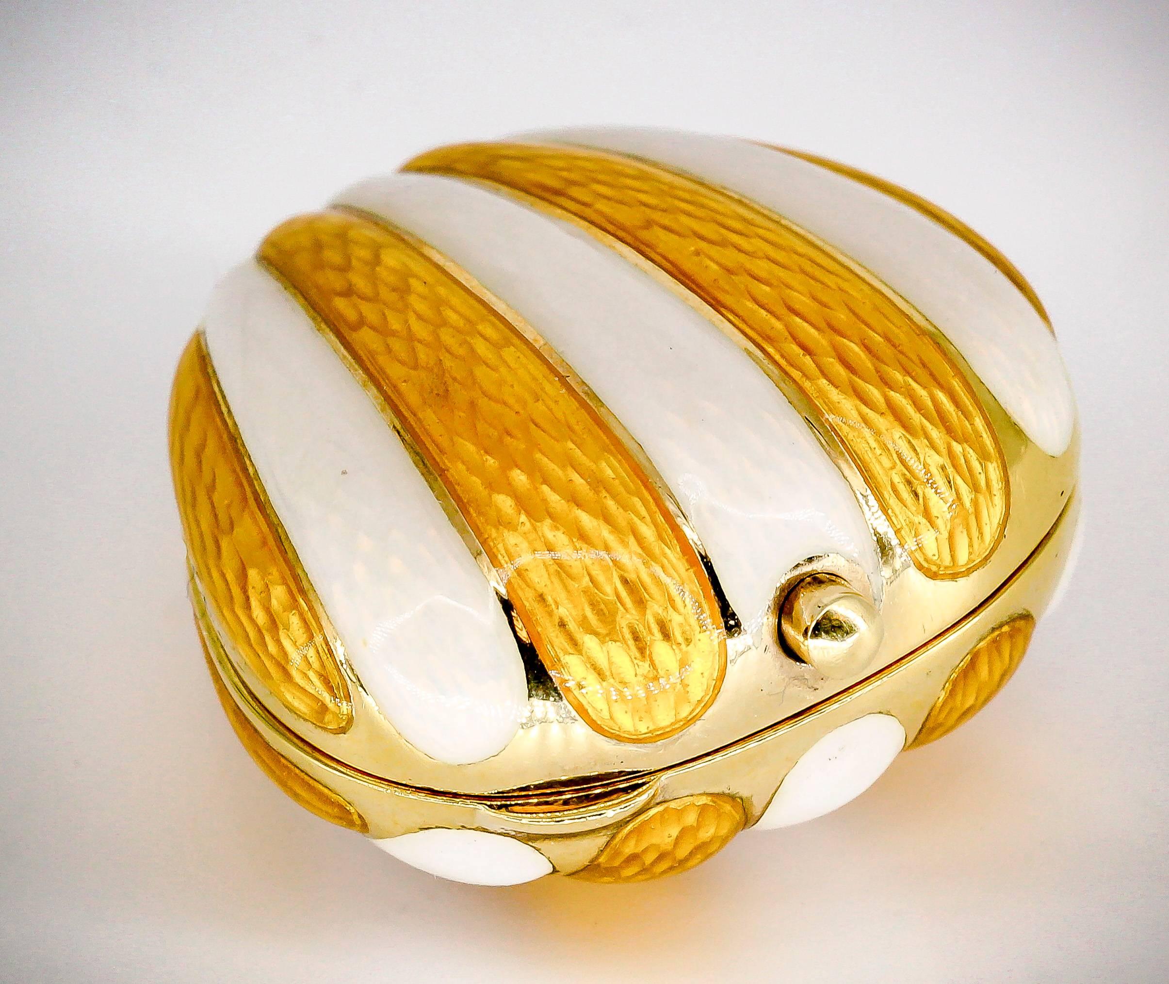 Whimsical white and yellow enamel over 18K yellow gold pill box in the loose likely of a scallop shell. It features a dual colored guilloche enamel ribbed design with beautiful finish, inside is smooth 18K gold. This is a thick pill box with