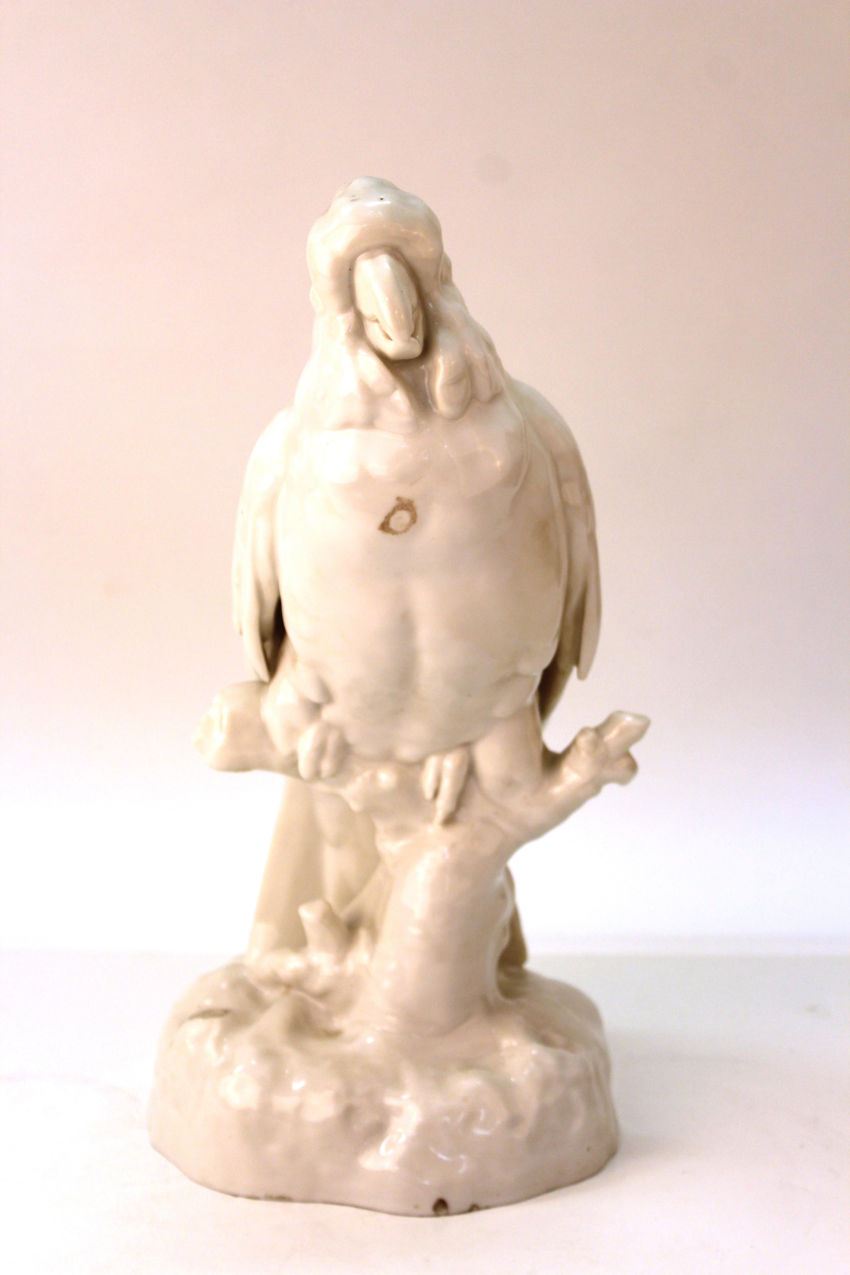 Continental white-glazed porcelain figure of a life-sized cockatoo perched on a branch, possibly German. Unknown makers mark on reverse of base. Several tiny old clam-shell chips, but overall in great antique condition.