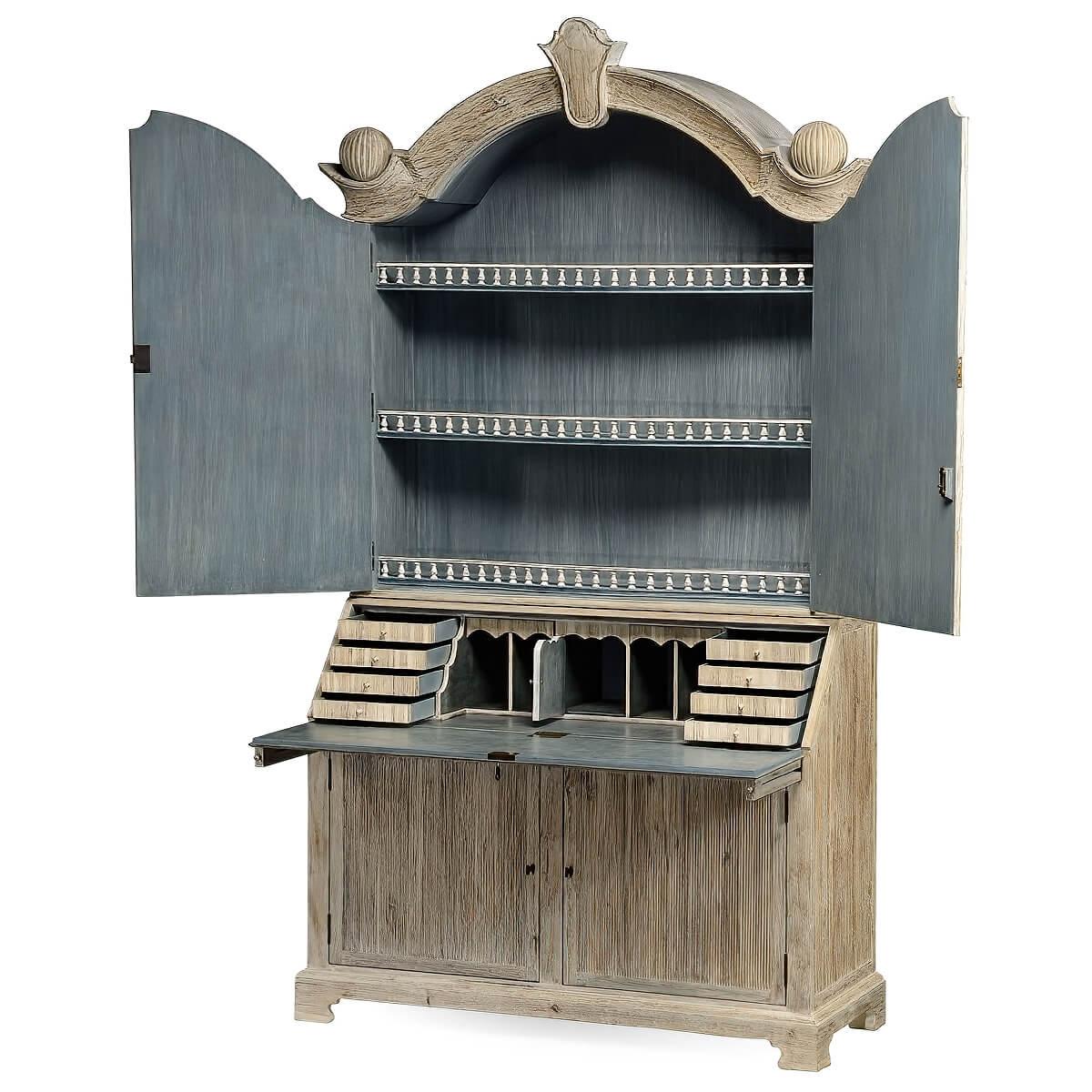 A wonderful designed modernized 18th century style secretary bookcase with a whitewashed exterior, with a carved cartouche mounted the center of the arched and molded crown with carved ball finials. The upper doors open to a three-shelf cabinet with
