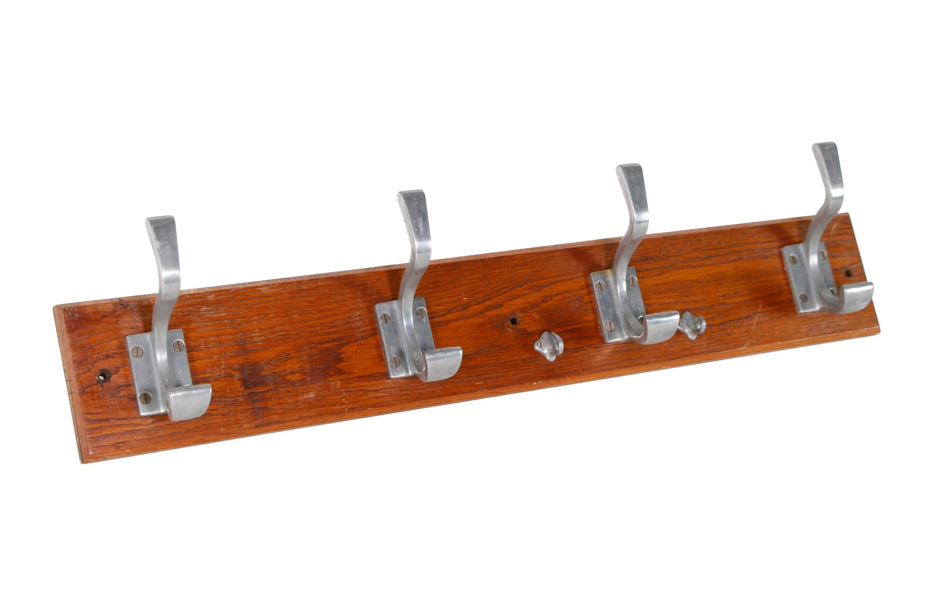 Imported from Europe, this wall mounted rack has a wood base with four large aluminum hooks and two tiny hooks centered on right side. This can be seen at our 400 Gilligan St location in Scranton, PA.