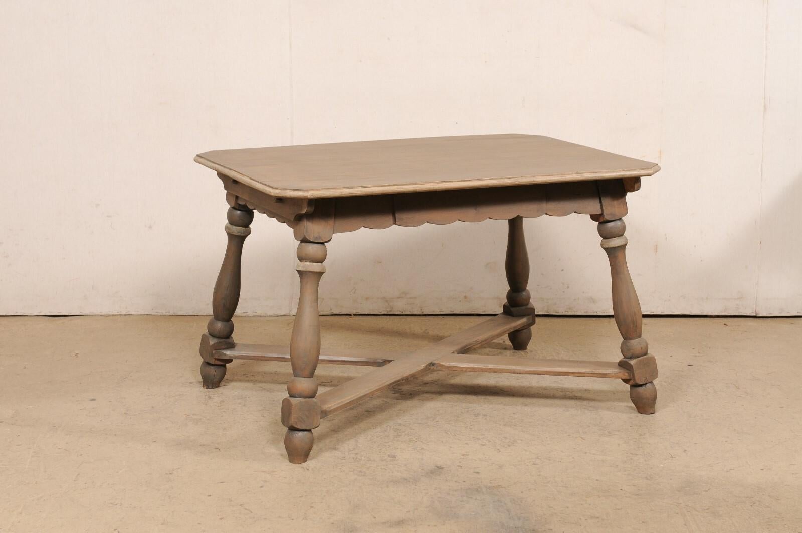 A European carved and painted wood occasional table from the 20th century. This vintage table from Europe has a rectangular-shaped top which rest above an apron which houses a single drawer at one long side, and sweetly carved with scallops about
