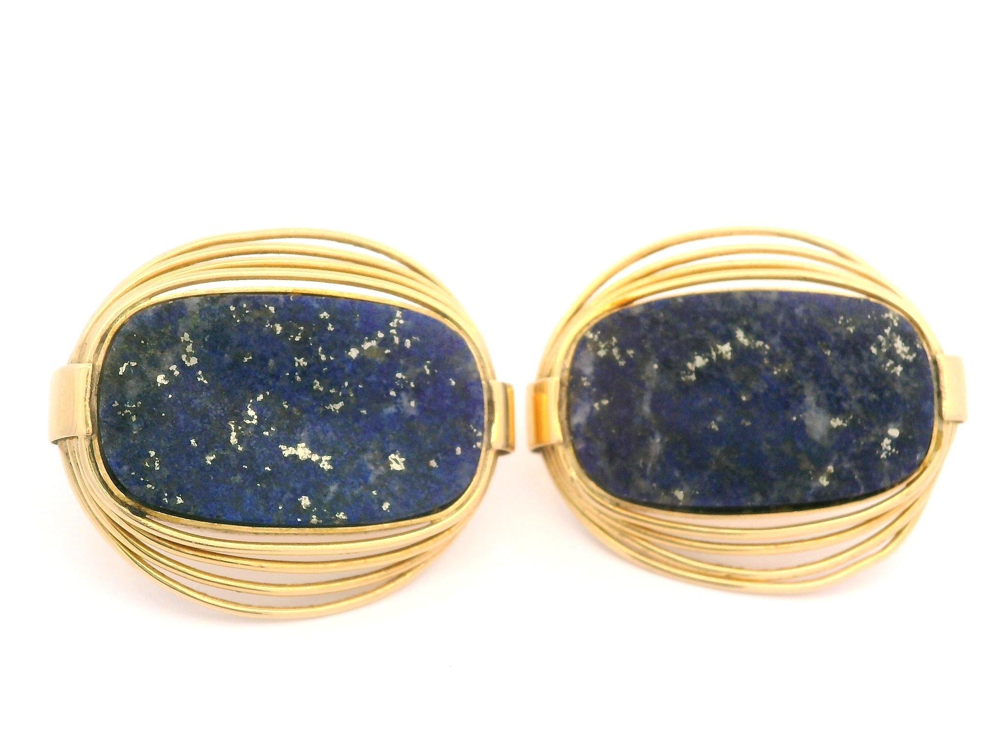 --Stone(s):--
(2) Natural Genuine Lapis Lazuli - Custom Cut - Bezel Set - Blue Color - 24.9x15.2mm each (approx.)

Material: Solid 18k Yellow Gold
Weight: 22.51 Grams
Backing: Post Backs w/ Omega Closures (Pierced ears are required.)
Width: 26.4mm