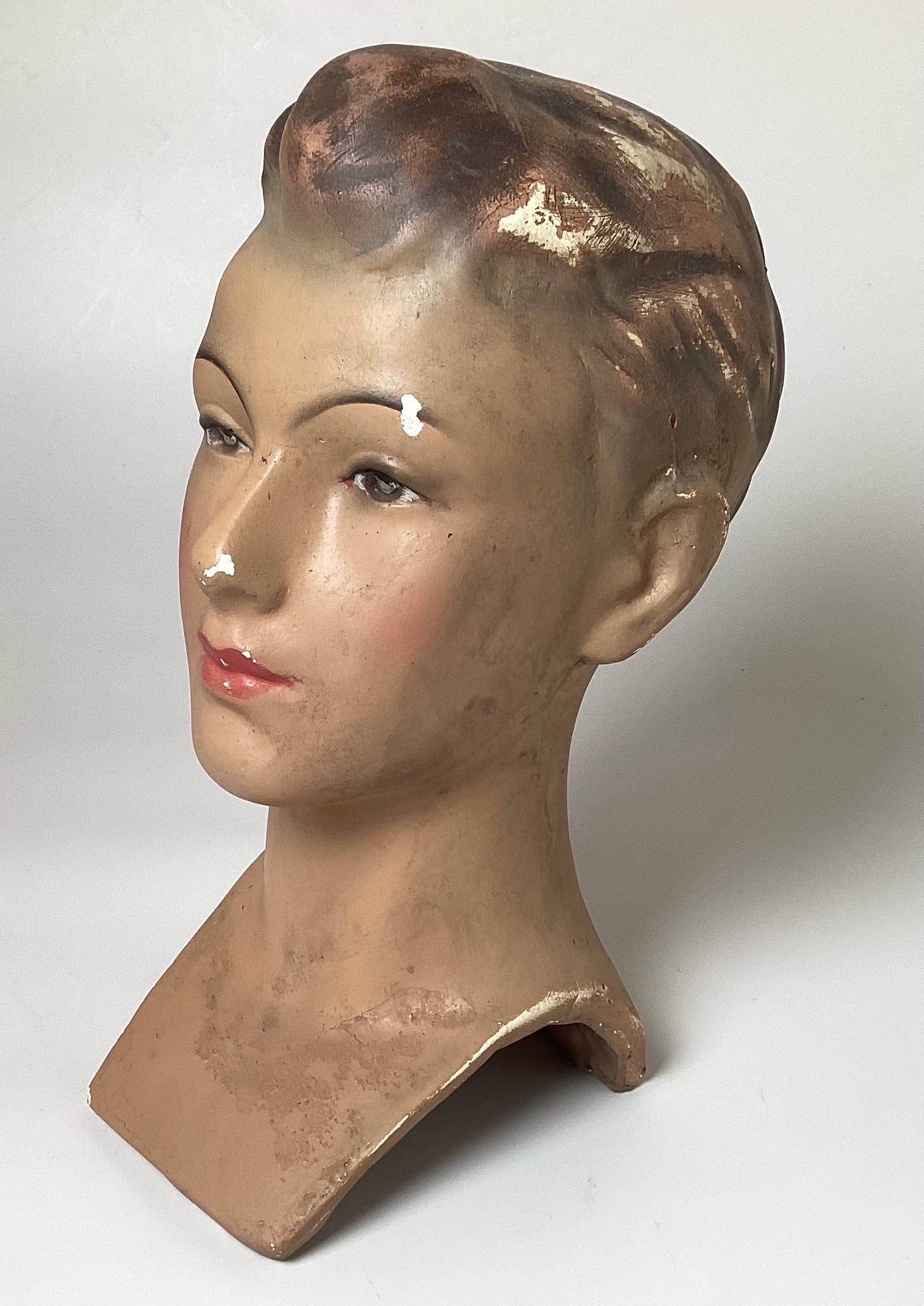 All original plaster mannequin head from a Belgium department store. The face of a teen aged young man with the original hand panted face and hair, made of a heavy plaster. Europe, 1940s 13 inches tall.