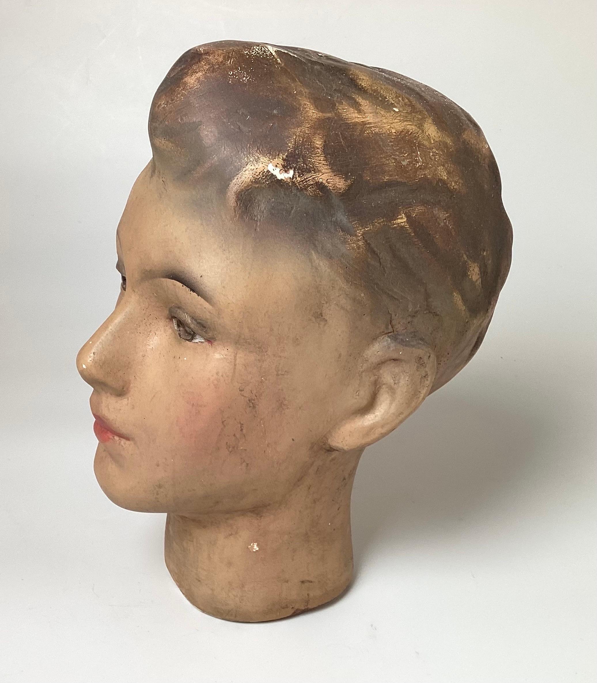 All original plaster mannequin head from a Belgium department store. The face of a teen aged young man with the original hand panted face and hair, made of a heavy plaster. Europe, 1940s 11 inches tall.