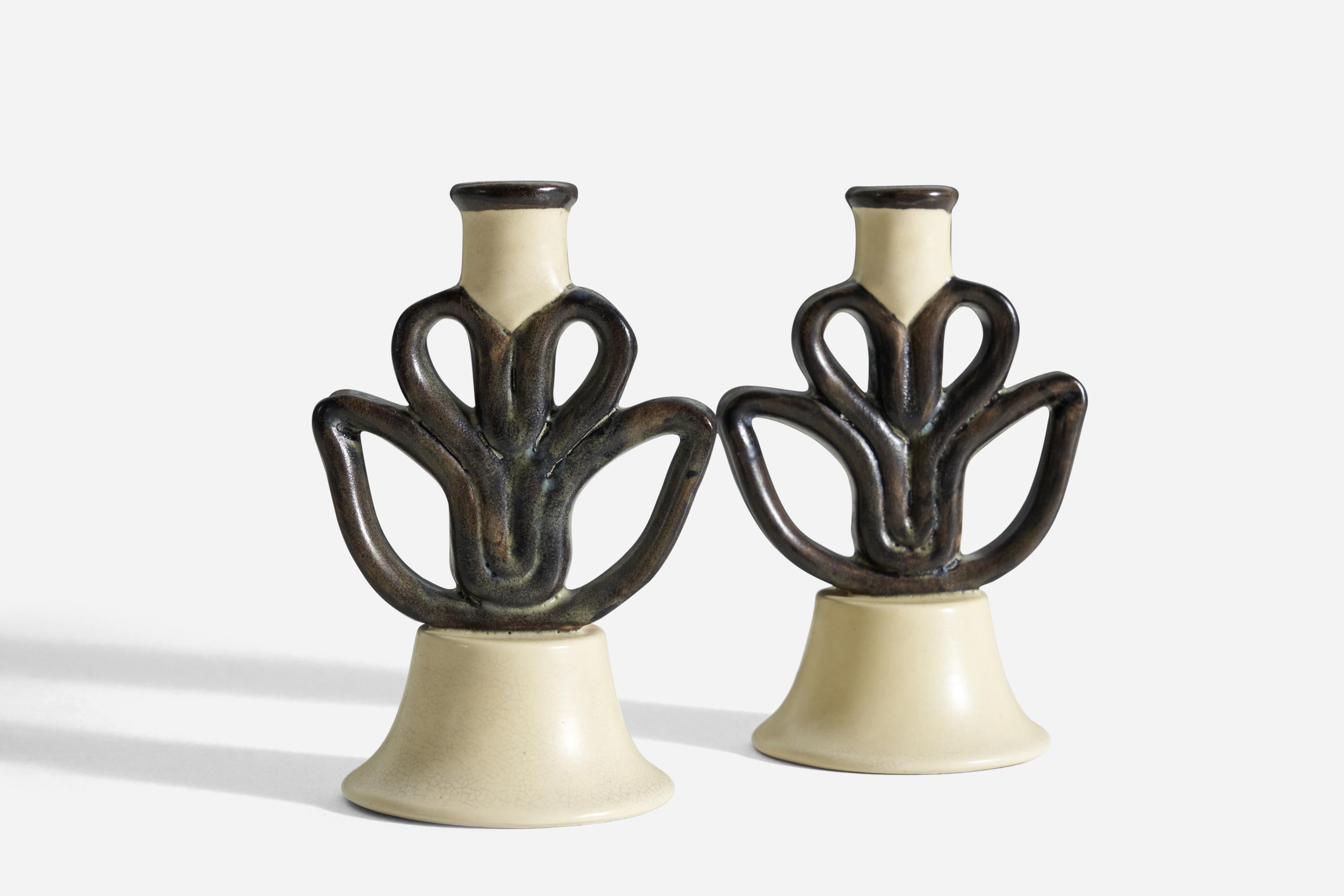 A pair of black and cream glazed earthenware candle holders designed by Eva Jancke Björk, for Bo Fajans, Sweden, 1940s. Stamped to underside. 


 