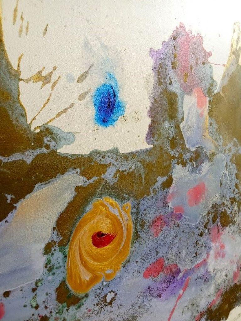 This abstract artwork captivates with its bold and dynamic interplay of color and form. Dominated by a central mass of textured blues, purples, and greens, the composition evokes a sense of fluidity and movement. Splashes of red and yellow add