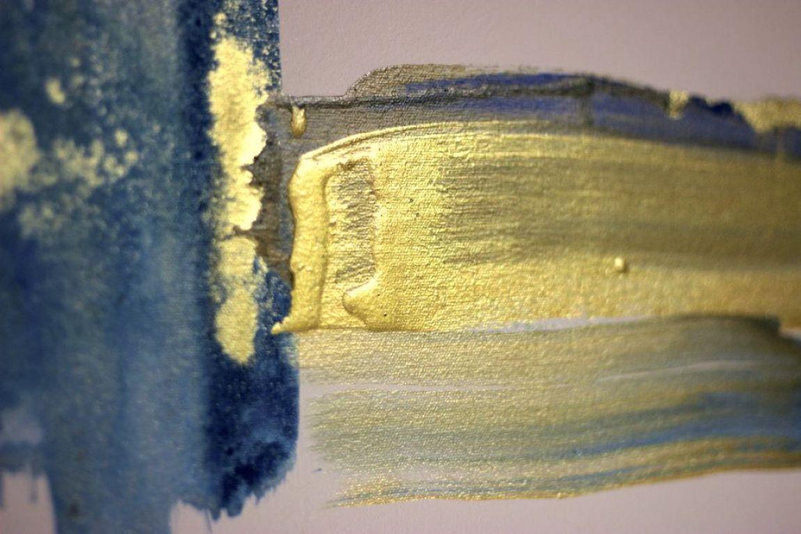 This artwork presents a striking blend of deep blues and shimmering golds, creating an evocative marine landscape. The fluid interplay of watercolor techniques infuses the piece with a sense of movement, reminiscent of ocean tides meeting sandy
