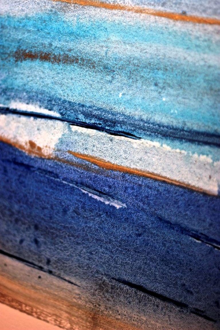 This artwork features a dynamic abstract composition characterized by horizontal brushstrokes in varying shades of blue, creating a sensation of fluidity and depth. The use of watercolor introduces a translucence to the piece, with tones ranging