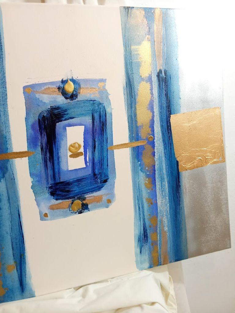 This artwork presents a striking interplay of bold blue hues and metallic gold accents, creating an aura of depth and opulence. Central to the composition is a series of blue rectangular forms, each layered with varying intensity, drawing the